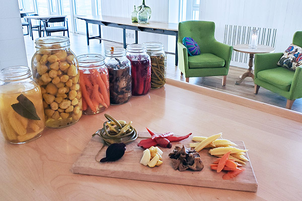 Pickled vegetables in jars and served on a board