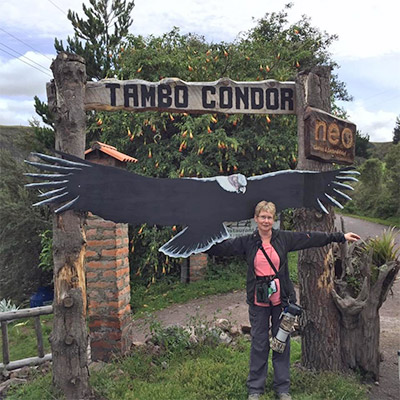 Woman with arms stretched next to Condor cutout